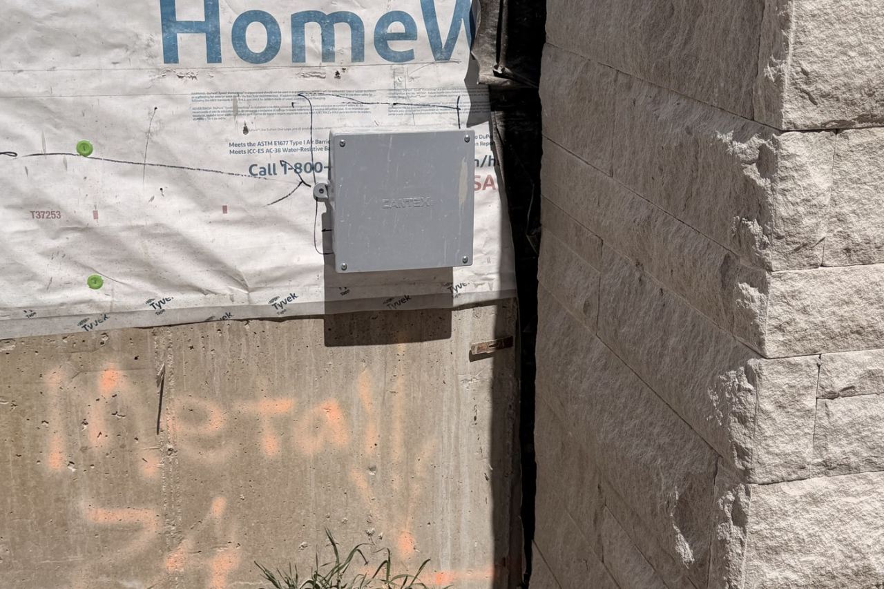 WattBox-style power and comm enclosure mounted prior to sheetrock — Utah County Estate