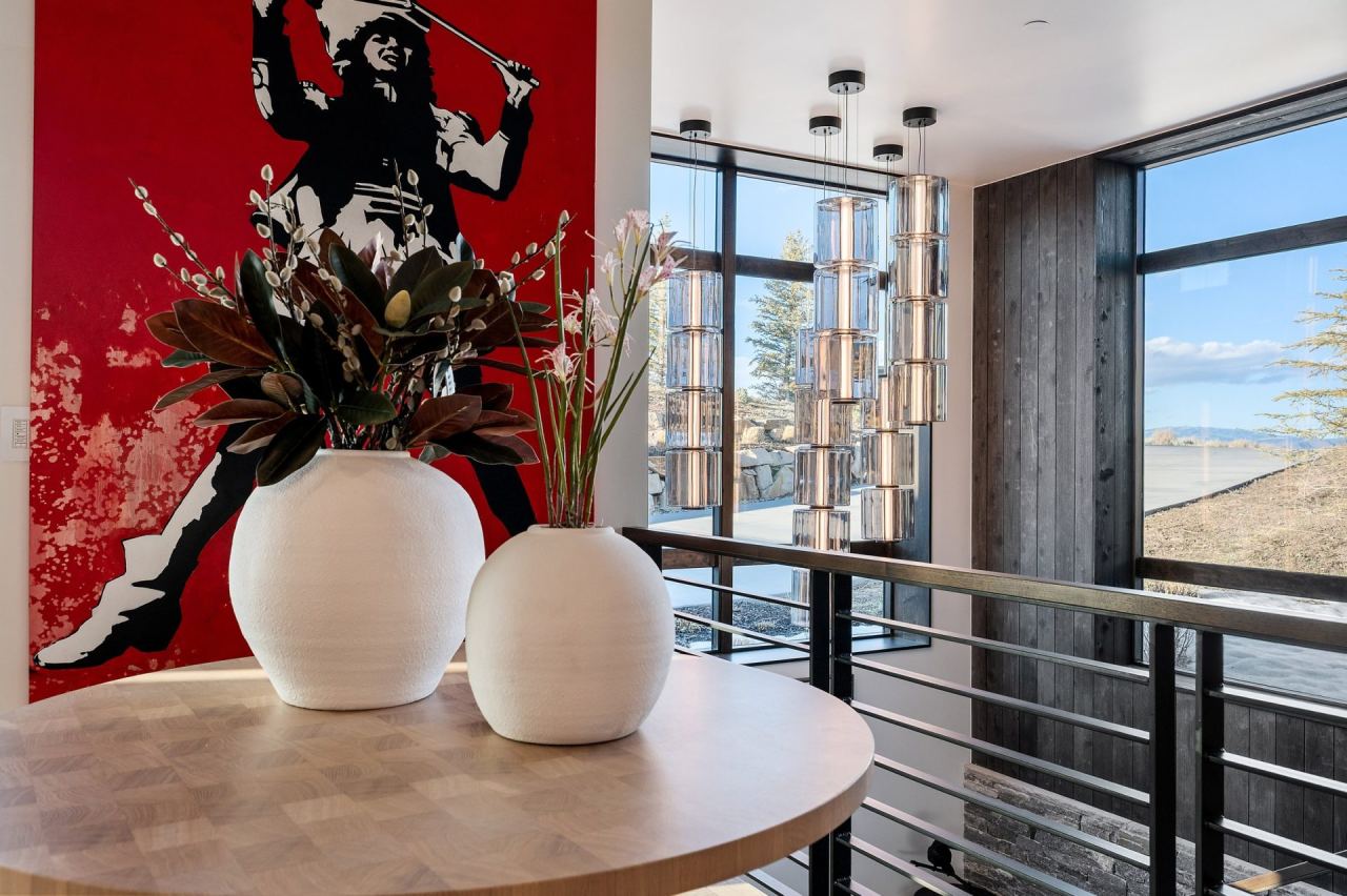 Round dining vignette with red Banksy canvas and crystal pendant chandelier &mdash; Park City home by Techi