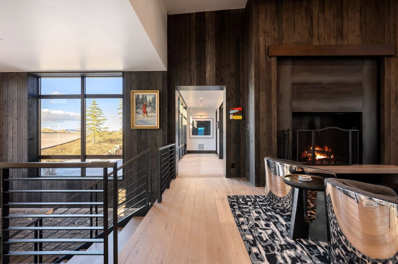 Hallway with linear gas fireplace and mountain-view window &mdash; Park City home by Techi