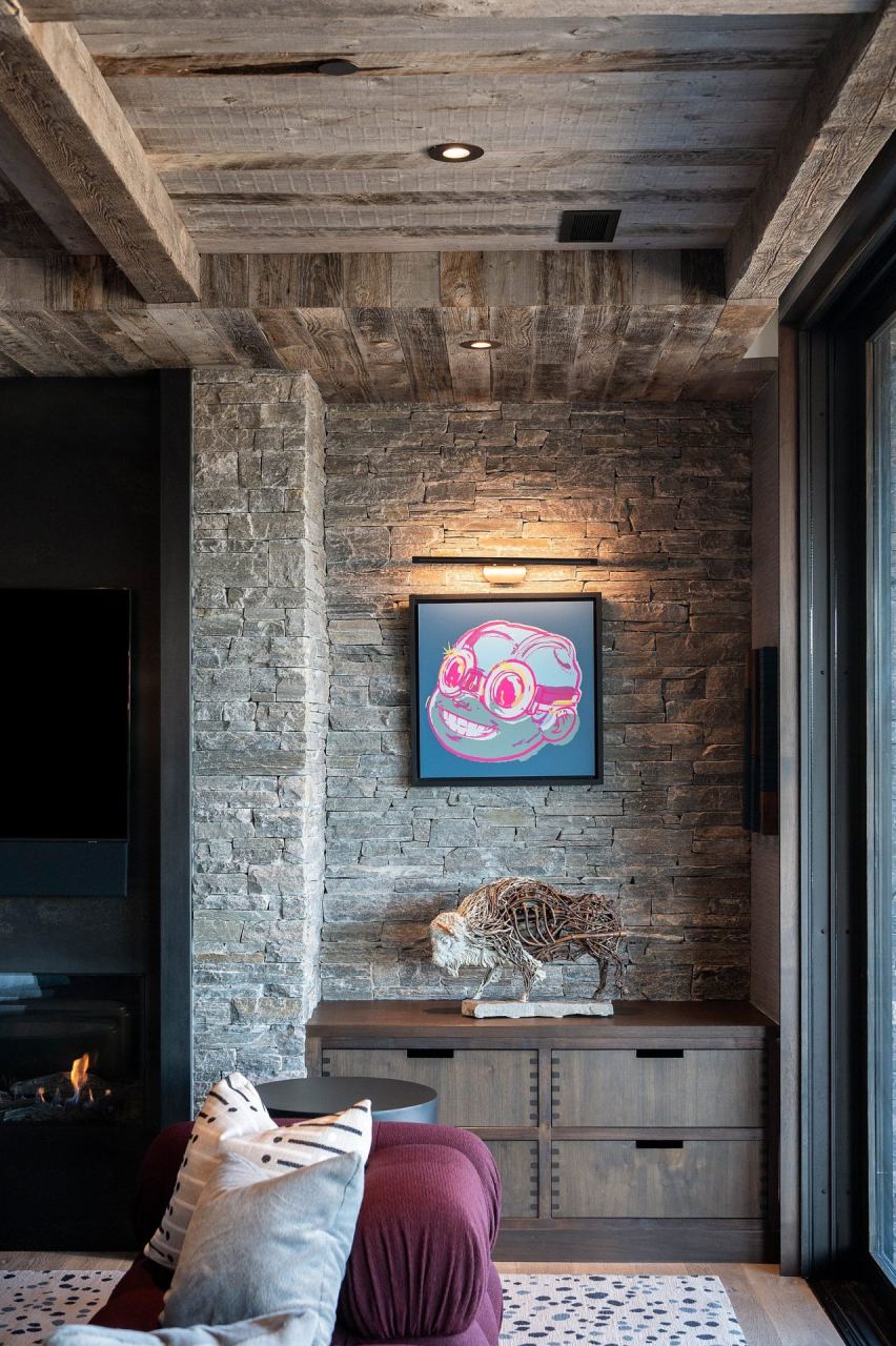 Stone wall niche with cartoon canvas and wicker bison sculpture &mdash; Park City home by Techi
