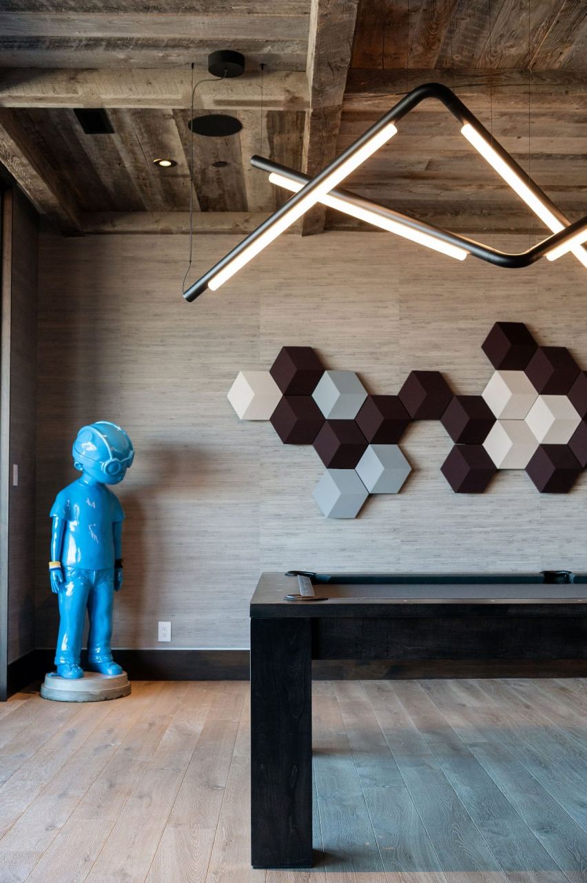 Reading area with blue figural sculpture and hex acoustic panels &mdash; Park City home by Techi