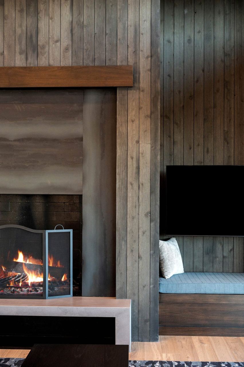 Stone-clad mass fireplace in a great room &mdash; Park City luxury home by Techi