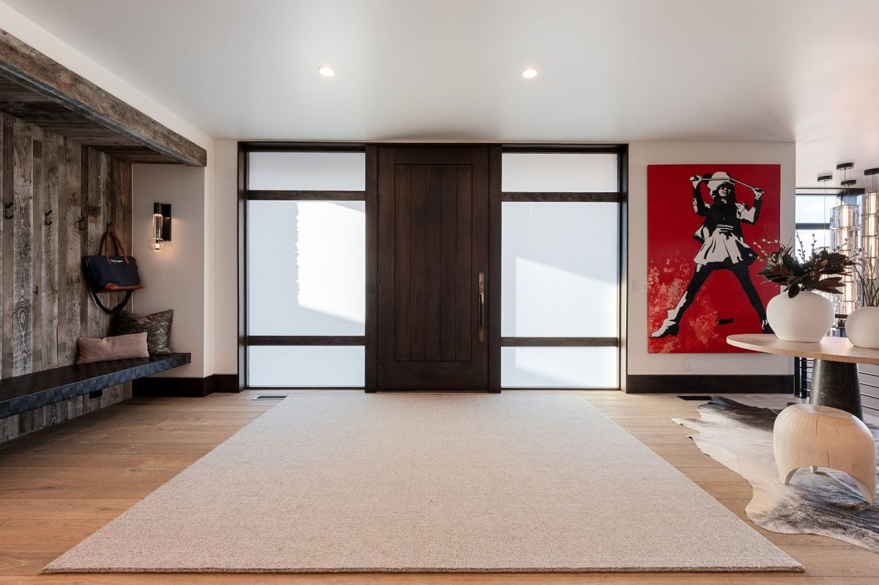 Two-story foyer with red Banksy canvas and architectural lighting &mdash; Park City home by Techi