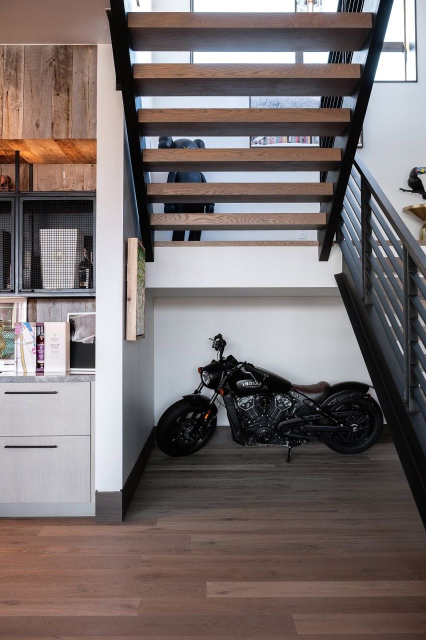 The Colony custom Indian motorcycle staged under floating steel staircase
