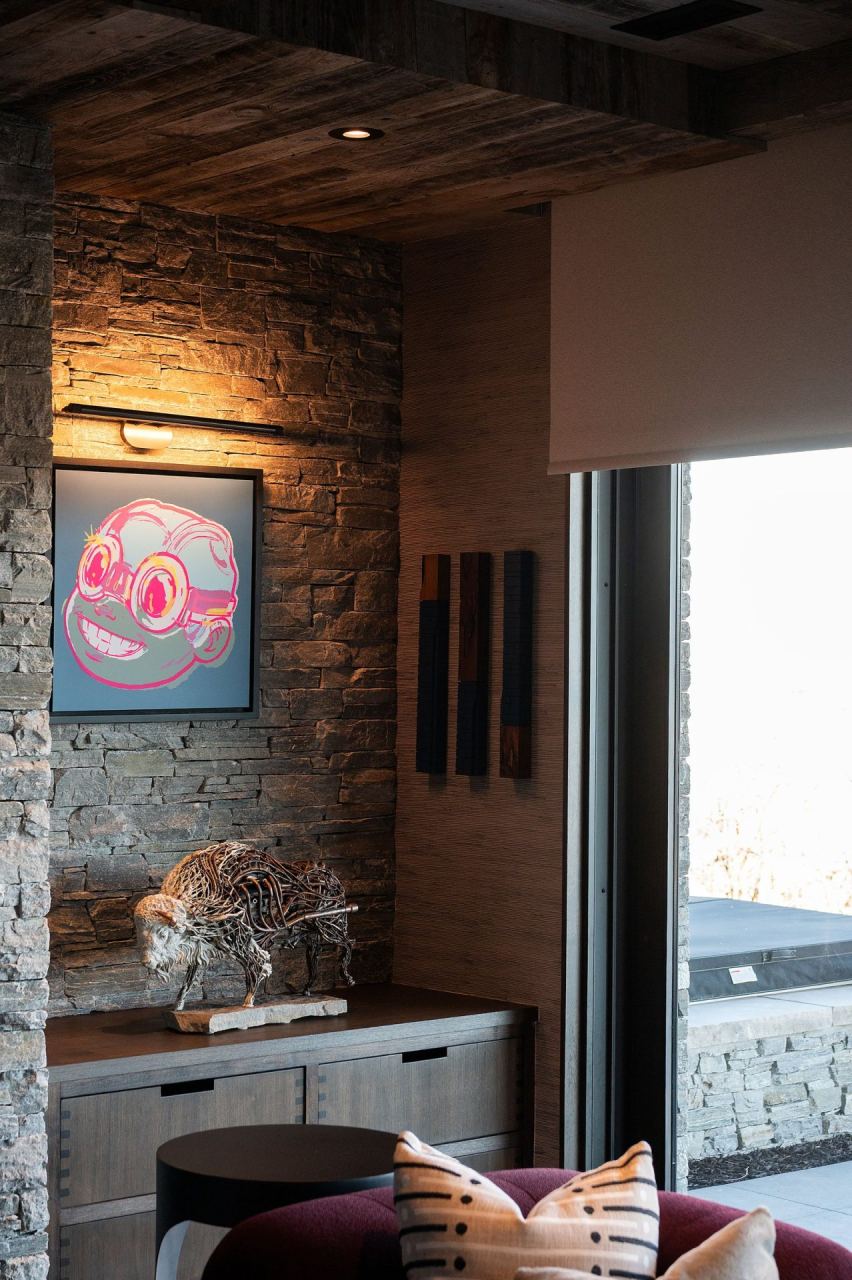 Stone-clad hallway gallery with mountain-view window &mdash; Park City luxury home by Techi