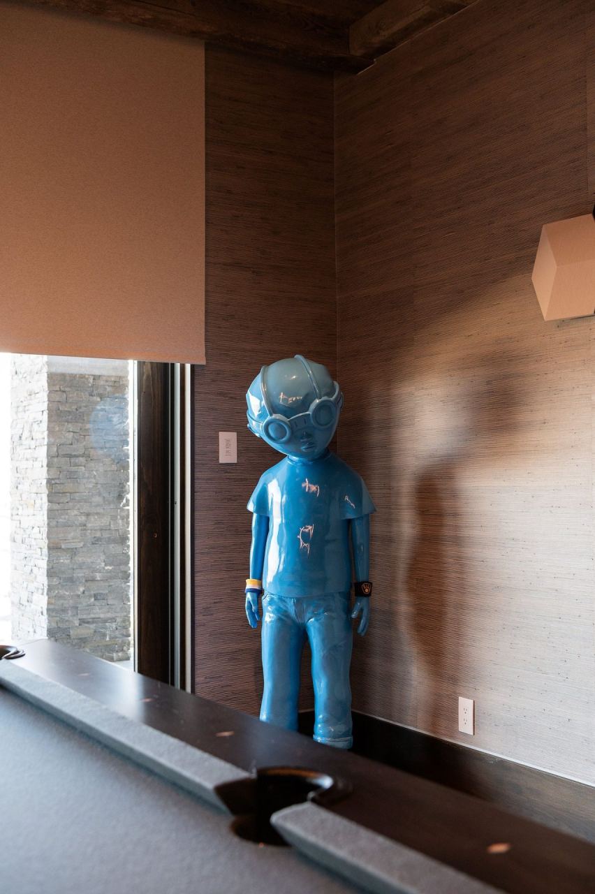Long gallery hallway with blue figural sculpture &mdash; Park City home by Techi