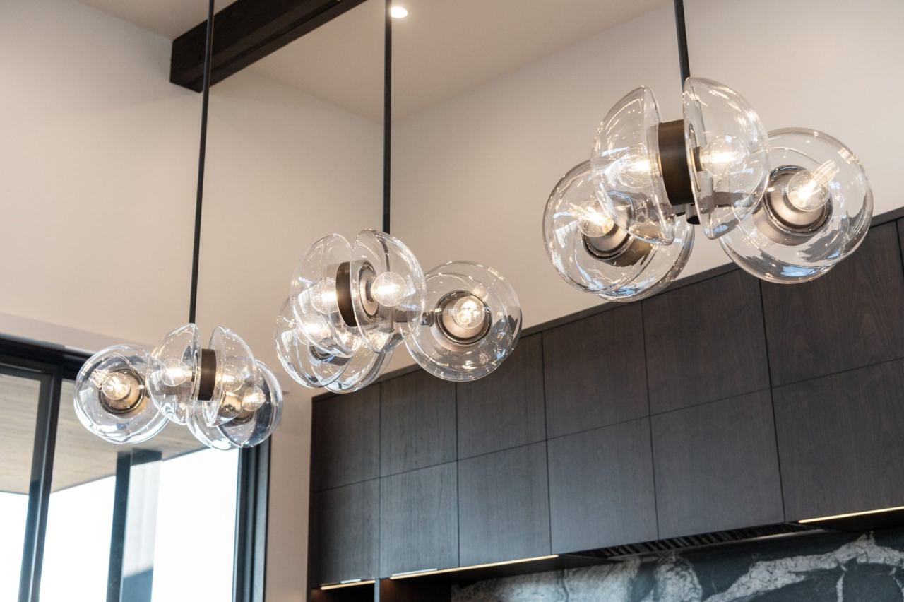 Cinema-style pendant chandelier and view-framed wall &mdash; Park City home by Techi